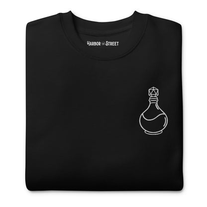 Black long sleeve crewneck sweater with white D20 potion bottle embroidered on the left chest and D20 Harbor Street logo on the right wrist