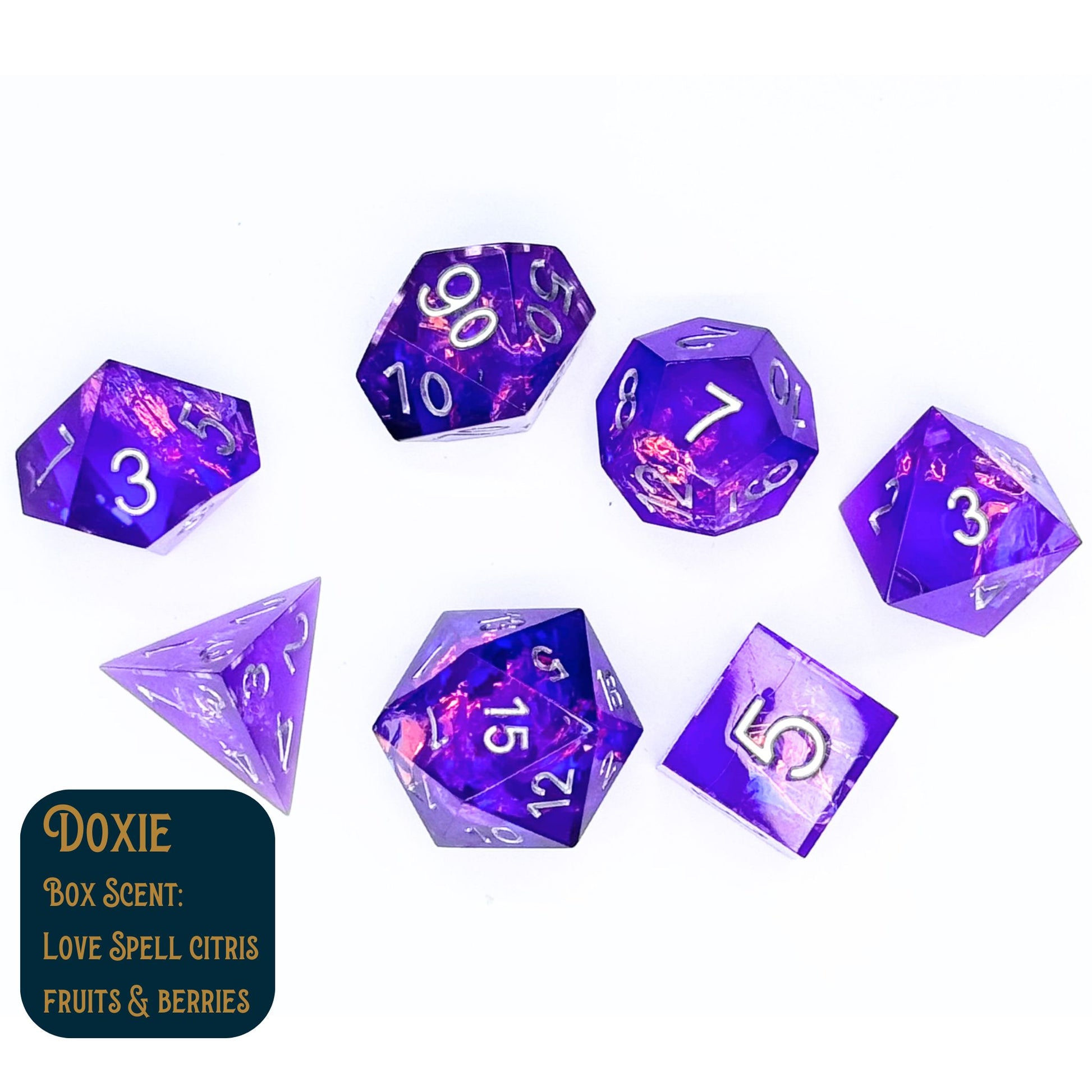 Doxie is a collection of seven polyhedral dice with a purple tint and cellophane in the center. Shown on a white background.