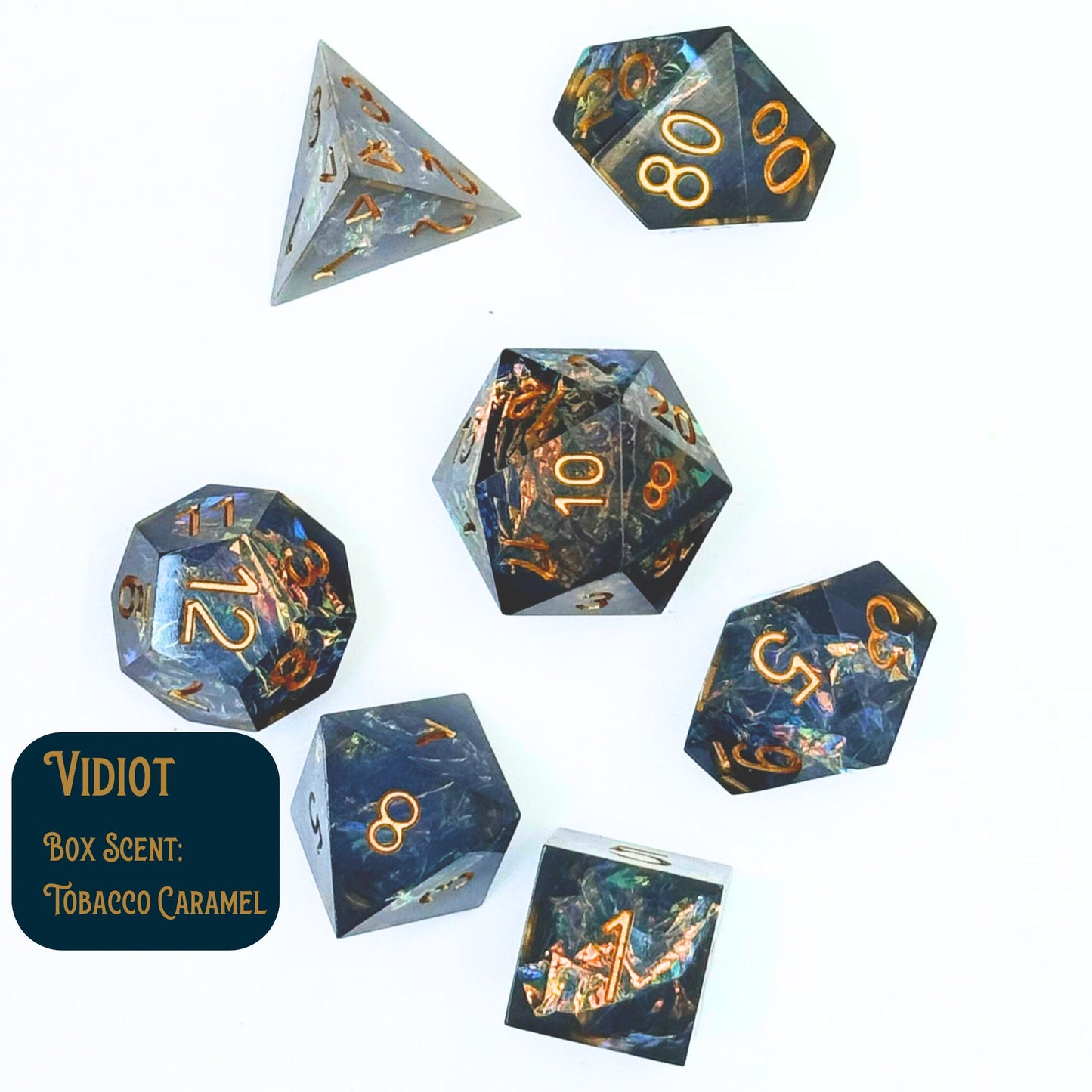 Vidiot dice collection of seven polyhedral dice with a blue-green tint and cellophane in the center. Shown on a white background